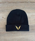 Actual black Voltare knit beanie sample on a wooden table, showing the folded cuff with solid gold V embroidery.