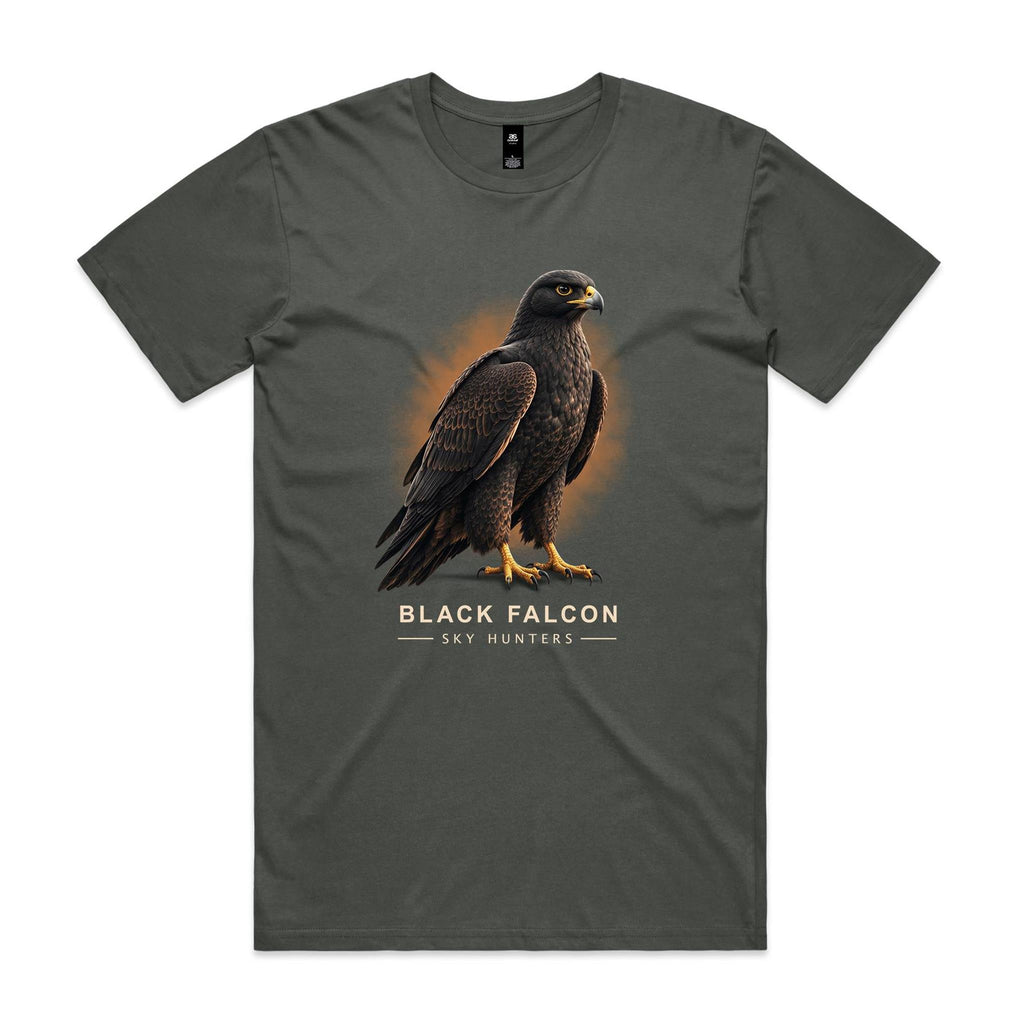 Front of the charcoal Voltare Black Falcon Sky Hunters T-shirt with a detailed dark-feathered bird and golden-yellow feet against a warm ochre backdrop.