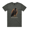 Front of the charcoal Voltare Black Falcon Sky Hunters T-shirt with a detailed dark-feathered bird and golden-yellow feet against a warm ochre backdrop.