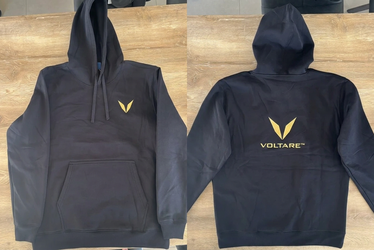 Front and back views of a black Voltare hoodie sample, showing the gold V embroidery on the chest and the gold V and VOLTARE wordmark below the hood.