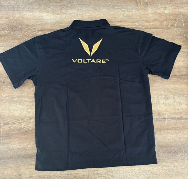 Actual black Voltare polo sample laid flat from behind, showing the gold V and VOLTARE wordmark embroidery below the collar.