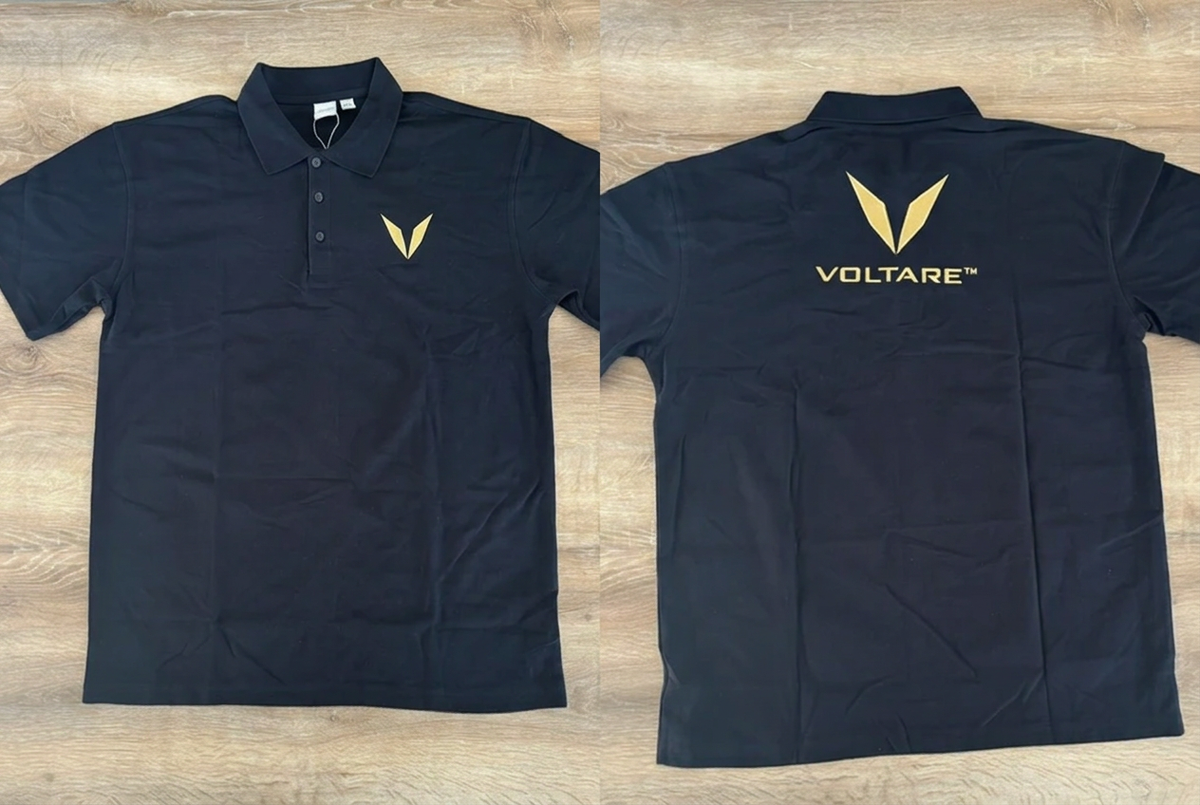 Front and back views of a black Voltare polo sample, showing the gold V embroidery on the left chest and the gold V and VOLTARE wordmark below the collar.