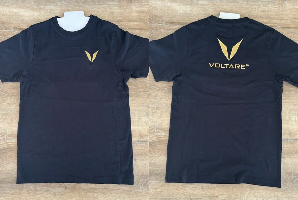 Front and back views of a black Voltare crew-neck tee sample, showing gold V embroidery on the left chest and the gold V and VOLTARE wordmark below the collar.