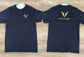 Front and back views of a black Voltare crew-neck tee sample, showing gold V embroidery on the left chest and the gold V and VOLTARE wordmark below the collar.
