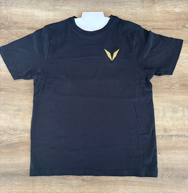 Actual black Voltare crew-neck tee sample laid flat, showing gold V embroidery on the left chest.