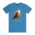 Front of the hydro blue Voltare Brahminy Kite Sky Hunters T-shirt with an illustrated bird featuring a white head and chestnut wings against a warm amber backdrop.