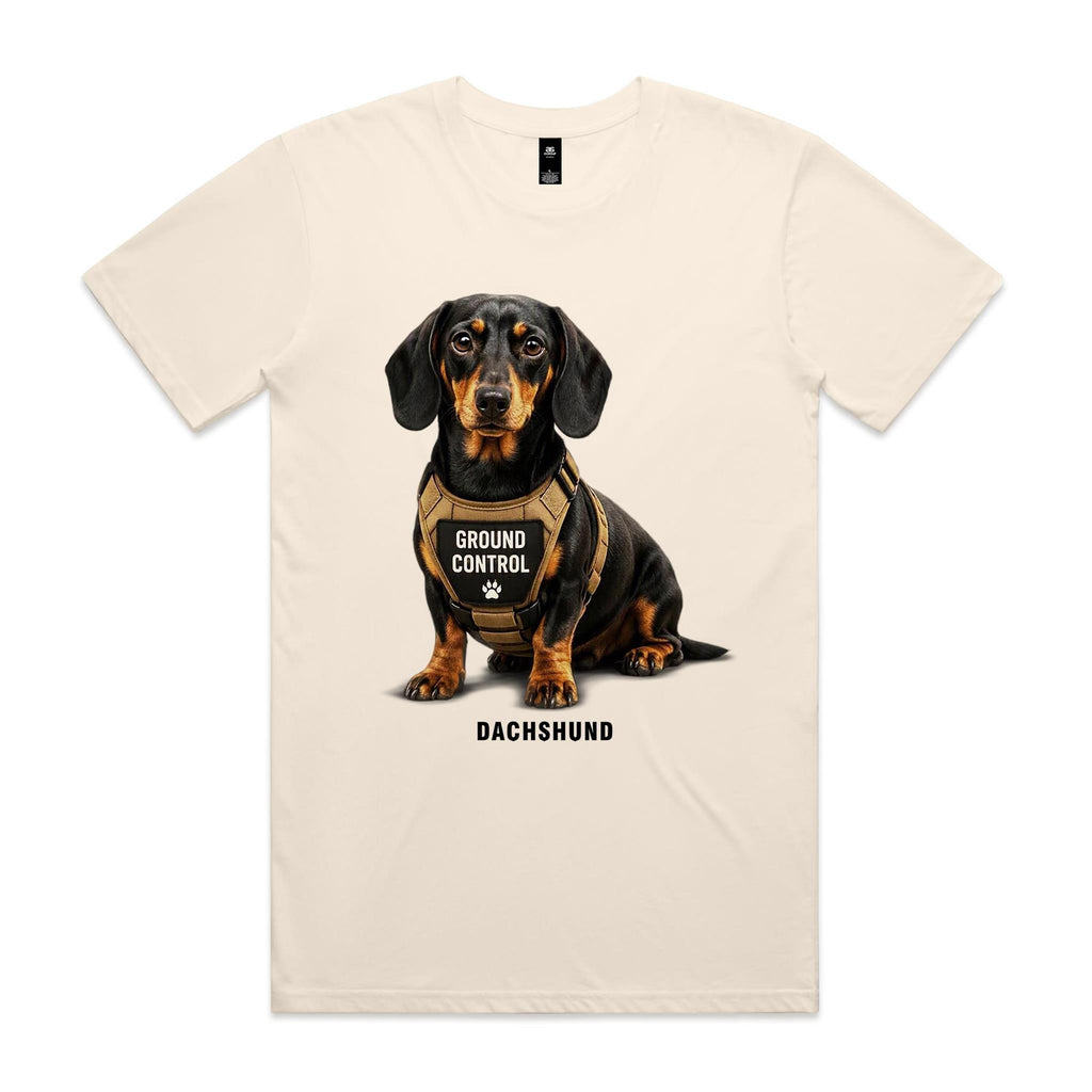 Voltare Dachshund Ground Control Tee in Ecru, front showing a black-and-tan Dachshund wearing a tan GROUND CONTROL harness above breed lettering.