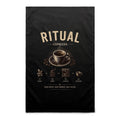 Voltare Espresso Ritual black tea towel with cream lettering, steaming espresso cup, coffee beans and illustrated coffee-making steps
