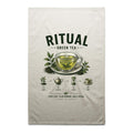 Voltare Green Tea Ritual cream tea towel with dark green lettering, steaming green tea cup, tea leaves, teapot and illustrated brewing steps
