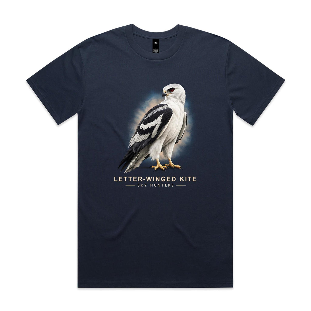 Front of the midnight blue Voltare Letter-winged Kite Sky Hunters T-shirt with an illustrated pale bird featuring bold black wing markings and a red eye against a blue-and-sand backdrop.