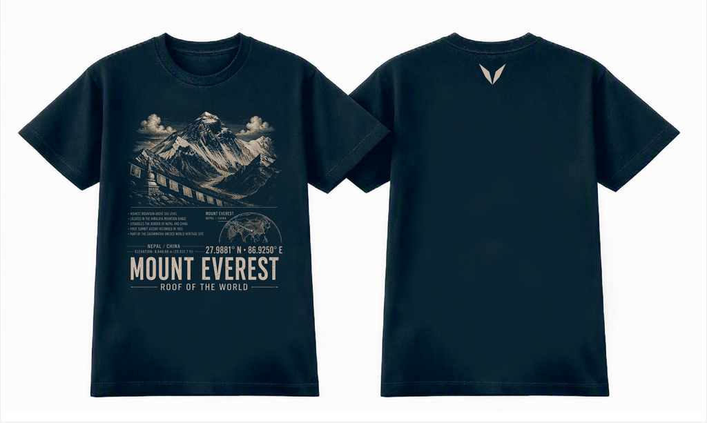 Front and back of the Midnight Blue Voltare Mount Everest Roof of the World tee, showing mountain and prayer flag artwork above facts, a map, coordinates and landmark lettering, with a small cream Voltare V high on the back