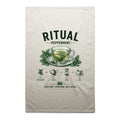 Voltare Peppermint Ritual cream tea towel with dark green lettering, glass tea cup and saucer, mint leaves and illustrated brewing steps