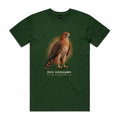 Front of the forest green Voltare Red Goshawk Sky Hunters T-shirt with an illustrated reddish-brown bird, dark wings and a patterned chest against a warm ochre backdrop.
