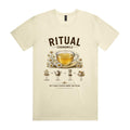 Front of the butter Voltare Ritual Chamomile T-shirt with an engraved glass cup of chamomile tea ringed with daisies and the four-step flowers, teapot, steep, cup method.