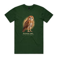 Front of the forest green Voltare Rufous Owl Sky Hunters T-shirt with an illustrated reddish-brown owl, a pale patterned chest and large dark eyes against a warm sandy backdrop.