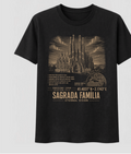 Front of the Black Voltare Sagrada Família Eternal Vision tee, featuring gold-toned basilica artwork above historical facts, a Barcelona location map, coordinates and Sagrada Família Eternal Vision lettering